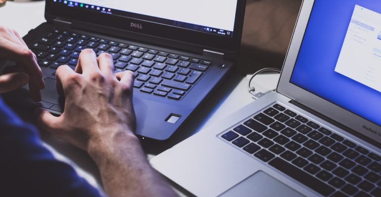 Person typing on a computer.